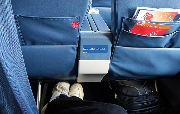 There was plenty of leg room in my seat located in the Economy Comfort section of the McDonnell Douglas MD-88 aircraft operated by Delta Air Lines. Photograph ©2015 by Brian Cohen.