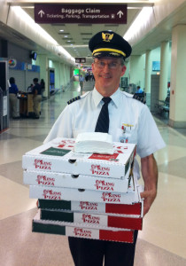Passengers of a delayed flight were treated to pizza — personally delivered by the beloved captain himself. Photograph courtesy of Denny Flanagan.