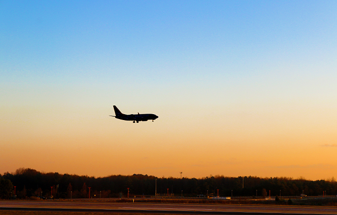 Airplane landing sunset