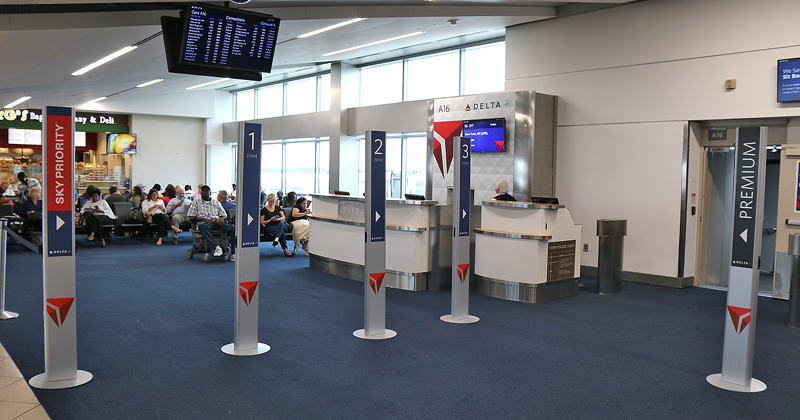 branded pillars boarding gate Delta Air Lines